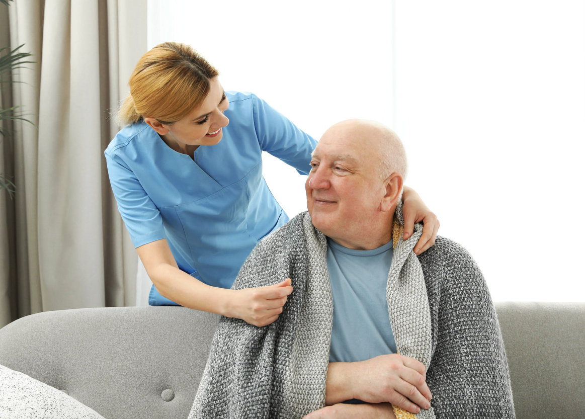 caregiver smiling at the senior man