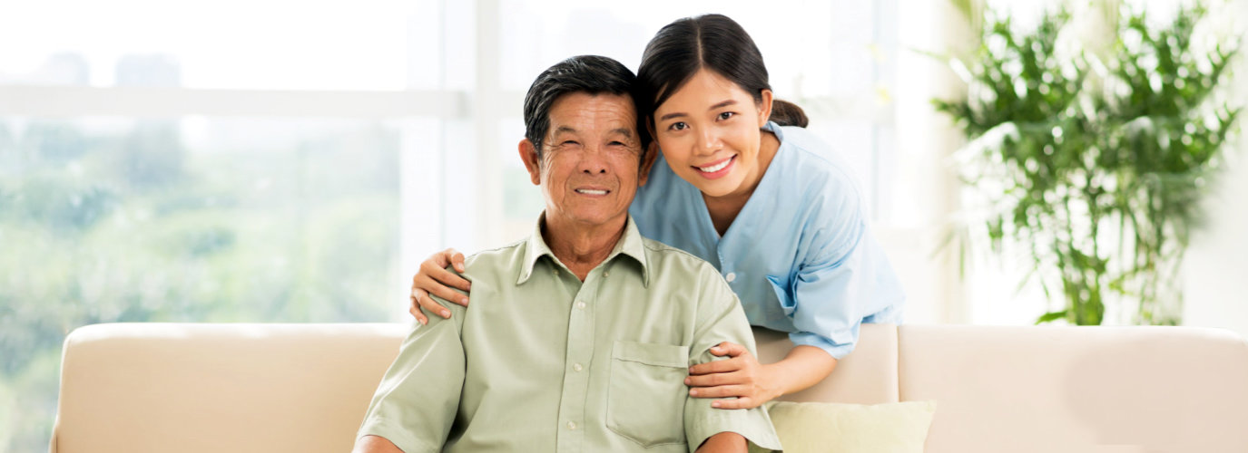 caregiver hugging senior woman